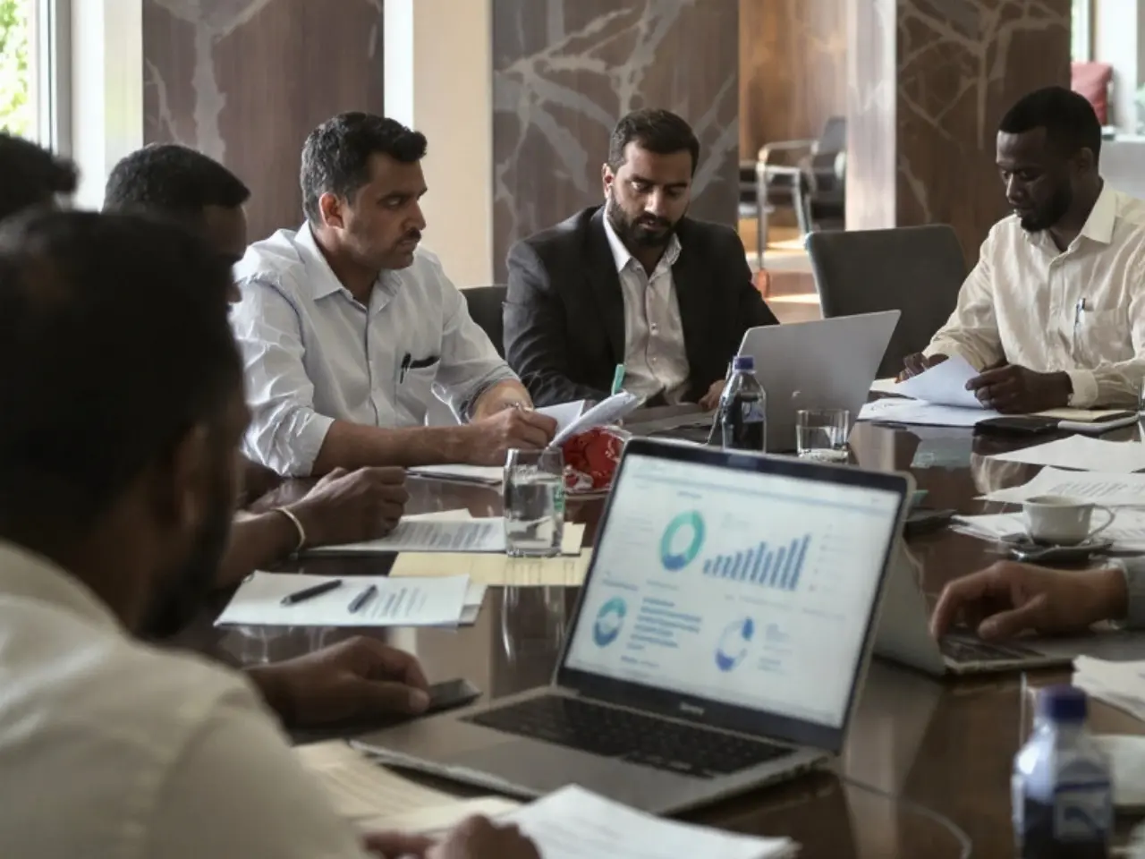 Photorealistic image of South Asian policymakers reviewing subsidy reform: 3 pillars of targeted support, stronger institutions, and social protection for vulnerable groups