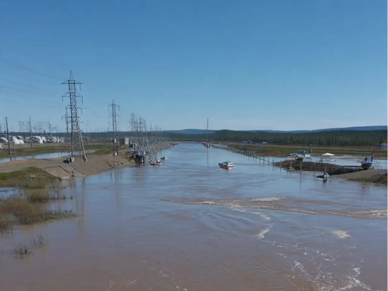 Photorealistic image of cross-border officials collaborating on flood risk management at a shared river basin, representing integrated water resources management and disaster resilience. This visual supports your theme that "Water Knows No Borders" and highlights IWRM, DRM cooperation, early warning